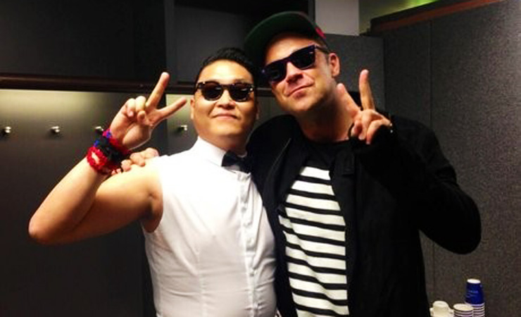 Psy and robbie williams pose together backstage at the summertime ballsite